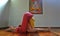 Young woman in halasana yoga pose