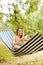 Young woman on hammock making a selfie