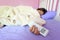Young woman hand hold remote air conditioner and sleeping in the