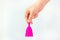 Young woman hand holding a pink menstrual cup like a bell