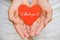 Young woman hand holding red heart paper with THANK YOU message.