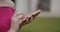 Young woman hand using smartphone, closeup portrait. people and college education. Female student studying and texting