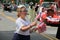 Young woman handing out flags in July 4th parade,Saratoga Springs,Ny,2013