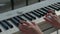 Young woman hands playing on electric piano