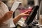 Young woman hands scaning, entering discount, sale on a receipt, touchscreen cash register, shop, finance concept