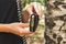 Young woman hands with small wallet card holder on the nature background.