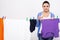 Young woman is hanging clothing on clothesline on white background