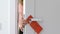 Young woman hanging do not disturb sign and closing door, privacy in hotel