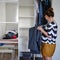 Young woman hangs clothes in the closet, lifestyle