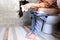 Young woman has constipation or hemorrhoids sitting on toilet, H