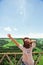 Young Woman in hat enjoying mountains landscape raised hands Travel Lifestyle happy emotions concept adventure outdoor active