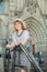 Young woman in hat standing on handrail and the stone stairs