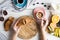 Young woman have a delicious breakfast with coffee,croissants,muffins and fruits on white wooden table.