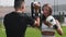 Young woman having a boxing training with her male coach - punching in mitts