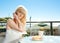 Young woman having breakfast on balcony