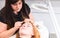 Young Woman Having Eyebrows Plucked in Spa