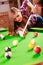 Young woman having fun with billiard.