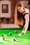 Young woman having fun with billiard.