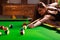 Young woman having fun with billiard.