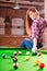 Young woman having fun with billiard.