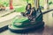 Young woman having fun in electric bumper car