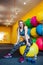 Young woman having rest at the gym. Muscular female relaxes and smiles after training while sitting on the ball.