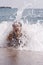 Young woman having some fun in ocean waves