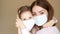 Young woman and her baby girl medical mask. Mother and daughter. Isolated on background. Health care and medical concept