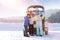 Young woman with her children on snowy road