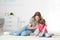 Young woman and her daughter drawing in living room