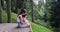 Young woman with her daughter sitting on wooden bench admiring nature