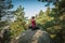 Young woman and her dog enjoy mountain hikes in summer