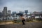 Young woman hides under an umbrella on a gloomy, rainy day in Inner Harbor Baltimore