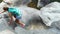 Young woman hiker climbing rock on mountain while summer hiking. Traveling woman with backpack hiking in mountain