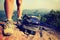 Young woman hiker legs climbing at mountain peak