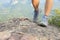 Young woman hiker legs climbing at mountain peak