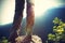 Young woman hiker legs on sunrise mountain peak