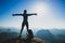 Young woman hiker stand on sunrise mountain peak cliff edge