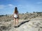 Young woman hiker surveys rocky terrain