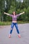 Young woman hitchhiking gesture at countryside