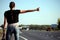 Young woman hitchhiking on the road