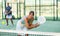 Young woman hitting two handed backhand during paddle tennis match