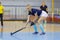 Young woman hockey player playing indoor hockey