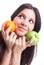 Young woman hold fruit - apple and orange.