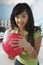 Young Woman Holding Ball At Bowling Alley