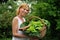 Young woman holding basket with vegetable