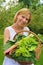 Young woman holding basket with vegetable