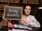 Young woman holding a black chalkboard in hands. Conceptual photo about Group Annuity with written text