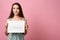 Young woman holding calendar with marked menstrual cycle days on pink background. Space for text