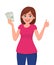Young woman holding cash/currency/money in hand and showing thumbs up sign. Deal, agree, approve, success, business and finance.